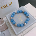 Blue Cat Eye Bead Bracelet with Silver Logo Cube Charms